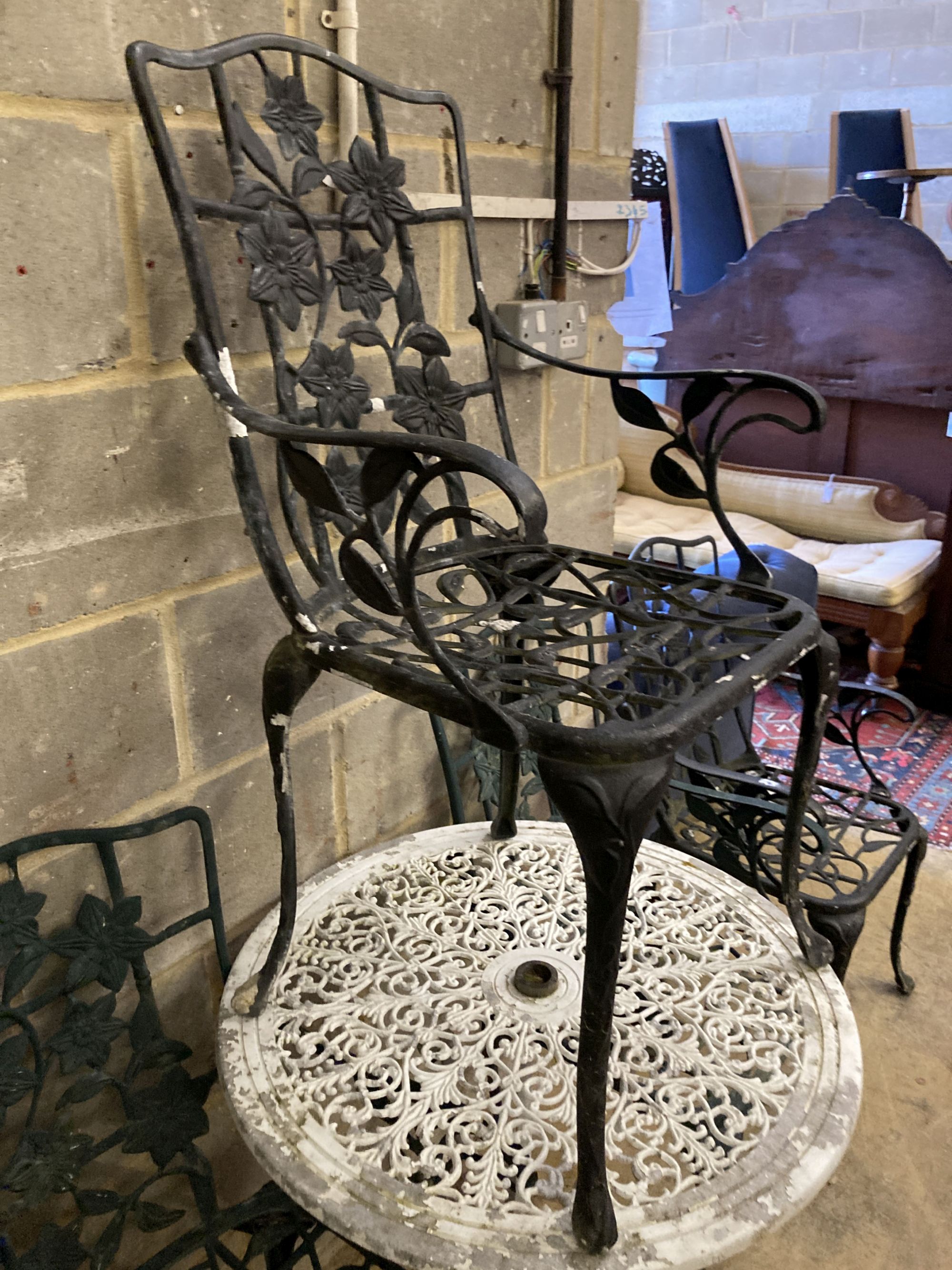 A Victorian style painted aluminium circular garden table, 69cm diameter together with a set of four garden elbow chairs